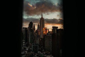 Empire state building at sunset with dramatic clouds