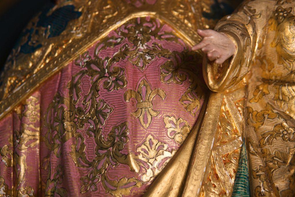 A close up of a statue of a person wearing a robe